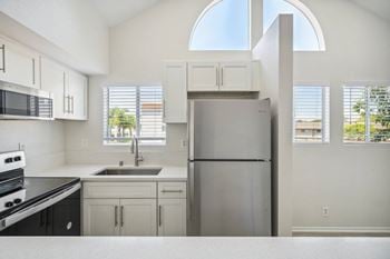 Sleek white shaker cabinets with brushed steel fixtures